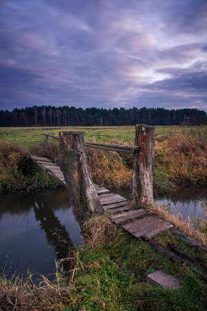 Bridge over the Jeziorka river at cloudy day near Piaseczno, Masovia, Polandの写真素材