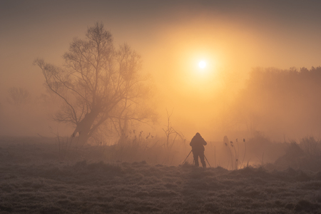 Photographer taking a picture in the valley of the Jeziorka river near Piaseczno, Masovia, Polandの写真素材