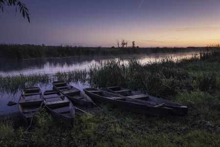 Wooden boats on Biebrza on a foggy morning, Goniadz, Podlaskie, Polandの写真素材