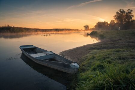 Wooden boat on Biebrza on a foggy morning, Goniadz, Podlaskie, Poland