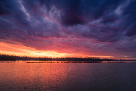 Storm clouds at sunrise on the Vistula near Konstancin-Jeziorna, Polandの写真素材