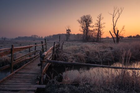 Wooden bridge over the Jeziorka river at sunrise near Piaseczno, Polandの写真素材