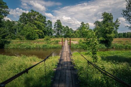 Wooden bridge over the Liwiec river at sunny day Korytnica, Masovia, Polandの写真素材