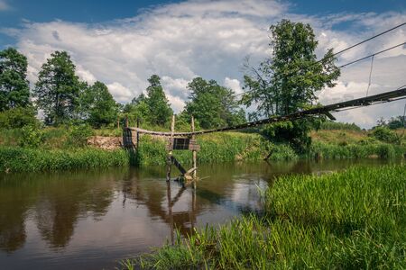 Wooden bridge over the Liwiec river at sunny day Korytnica, Masovia, Polandの写真素材