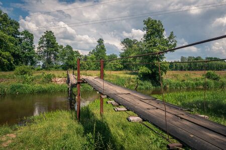 Wooden bridge over the Liwiec river at sunny day Korytnica, Masovia, Polandの写真素材