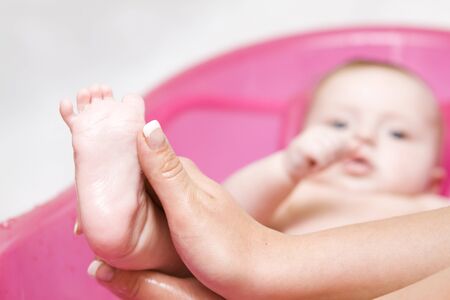 Little baby having fun in bathの写真素材