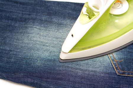 Ironing jeans on a white baclgroundの写真素材