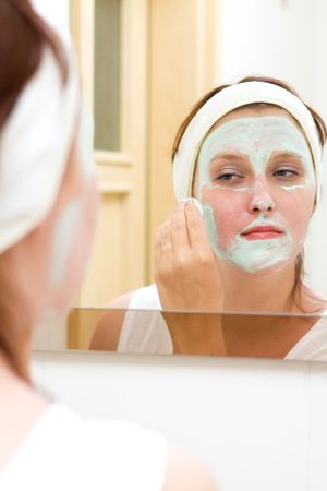 Woman in bathroom with beauty masの写真素材