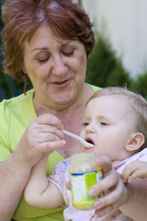 Grandmother and her granddaughter in gardenの写真素材