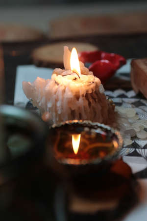 Burning short candle, reflection of fire in tea bowl with colorful painting during tea ceremonyの写真素材