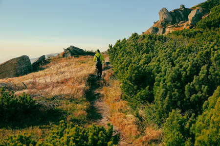 Hiking in the mountains. A man walks along the trail.の写真素材