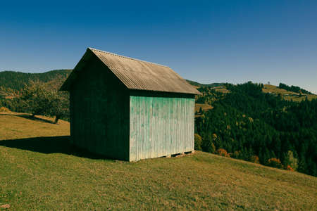 Old wooden shed on a meadow in the Carpathian mountainsの写真素材