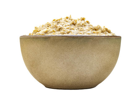 Porridge in a stoneware bowl on a white backgroundの写真素材