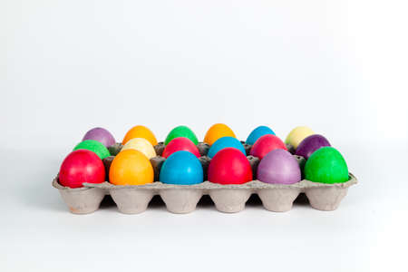 Painted Easter eggs in egg box
Multicolored, painted Easter eggs in egg box on white backgroundの写真素材