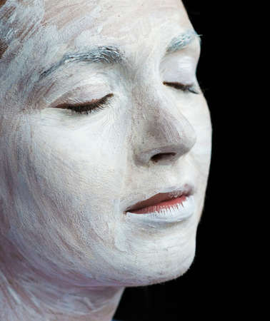 Applying makeup to beautiful young woman faceの写真素材