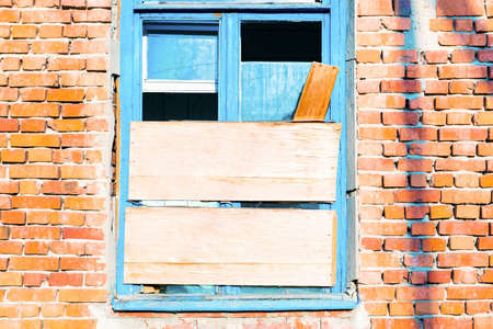 Old broken window on the old wallの写真素材
