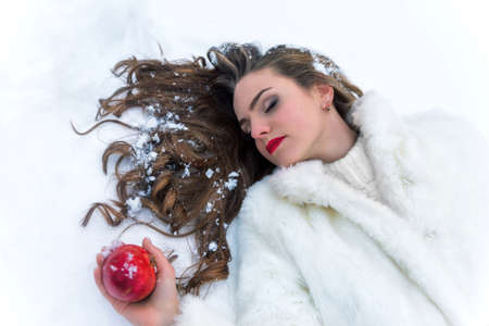 snow white girl poisoned with red appleの写真素材