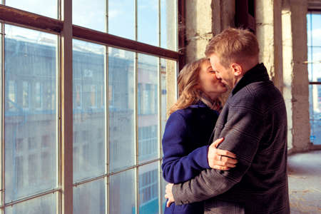 Couple stands near large window on construction siteの写真素材