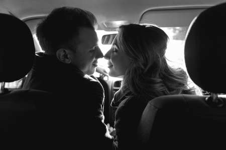 Romantic couple looking to each other in the car