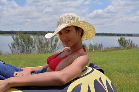 Cute young girl at the lakeの写真素材