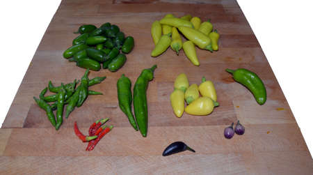 Different peppers on chopping blockの写真素材
