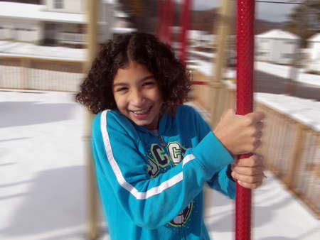 Child with braces spinning in the parkの写真素材