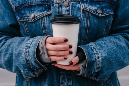 hipster girls hands holding a hot drinkの写真素材