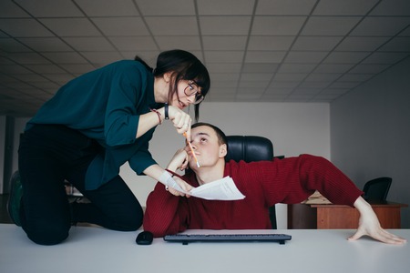 Young girl office worker yells at his staff. The situation in the modern office.の写真素材