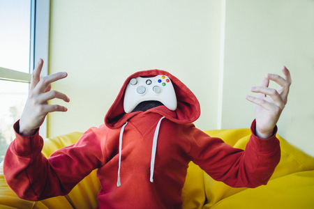 Portrait of a gamer is instead face a joystick for video games. The concept of video games.