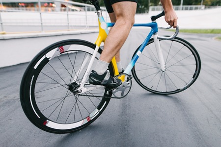 A professional cyclist rides on a beautiful and vibrant city bike.の写真素材
