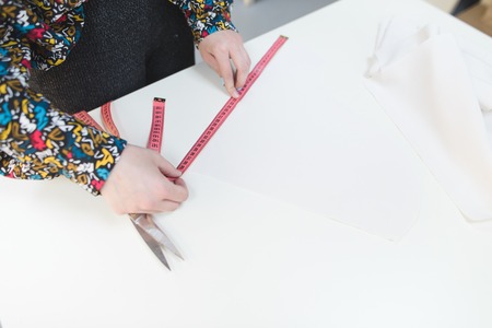 Hand seamstress length tape measure on white background. Sewing concept. Copyspace.の写真素材