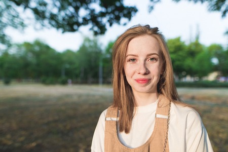 Portrait of beautiful smiling redhaired girl, outdoorsの写真素材