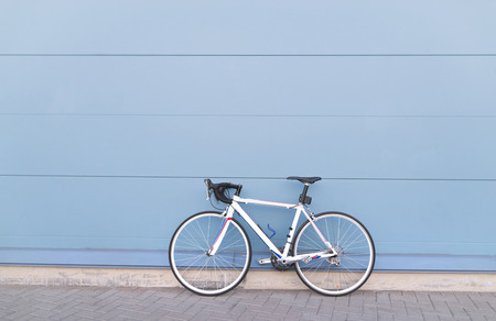 White highway bike on a pastel blue background. Sports concept. Copyspaceの写真素材