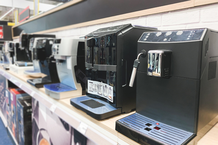 Coffee machines in a technology store. Choosing and buying a coffee machine on the shelves of the electronics store. Copyspaceの写真素材