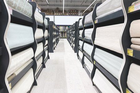 Department of wallpaper in the supermarket. Choose and buy wallpapers for the store. Many different wallpapers in the showcaseの写真素材