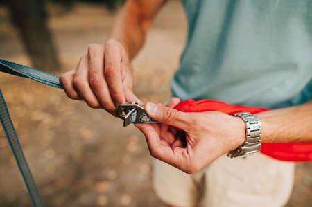 Close-up photo of men's hands are connected by slings with hooks. Tourism, Active rest.の写真素材
