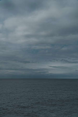 Dark clouds over the sea. Dramatic sky. Epic seascape. Nature, environment, ecology