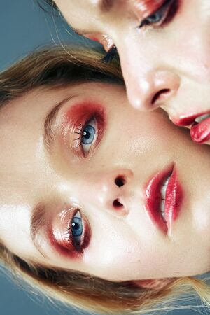 Beautiful blonde woman with a mirror. Professional portrait in a photo studio.の写真素材