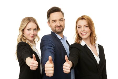 Businessman with two beautiful businesswomen. Teamwork. Thumbs up.