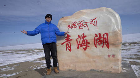 A man is standing on the shoreの写真素材