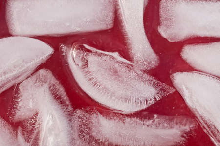Ice cubes in a red drink close upの写真素材