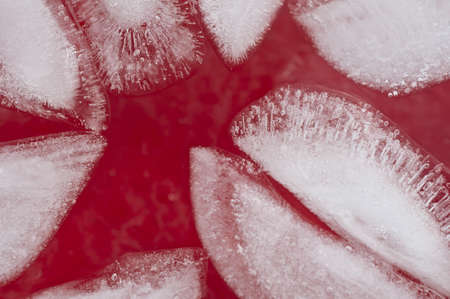 Ice cubes in a red drink close upの写真素材