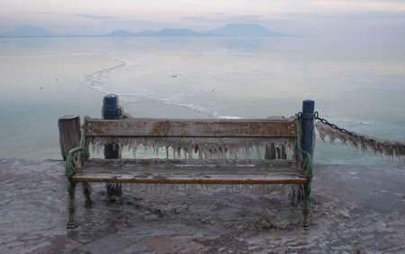 Icicles on a bench of a landing stageの写真素材