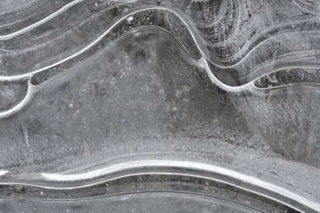 Ice on the lake surface forms beautiful patternの写真素材