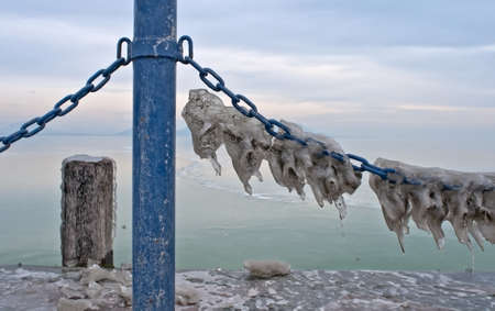 Icicles on a chain of a landing stageの写真素材