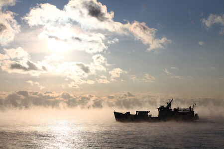 Hard frost and wind and sun  Evaporation from water surface at hard frost の写真素材