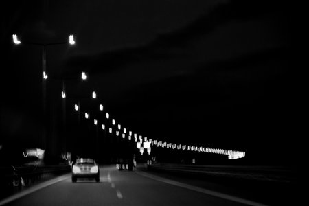 Car on the road at night. Black and white photo. Long exposure.の写真素材