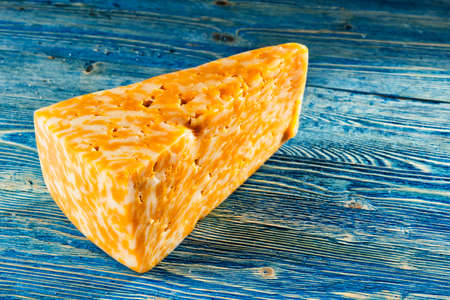 Aromatic fresh piece of cheese lying on the tableの写真素材