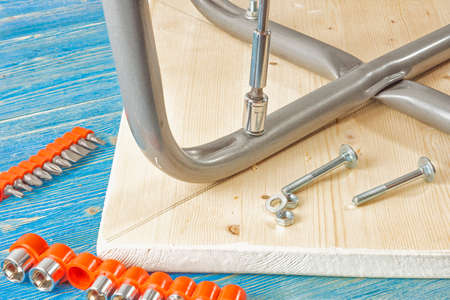 Tightening the nut on the stool with a socket wrenchの写真素材