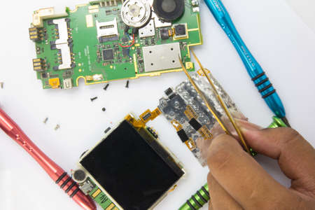 Mobile phone repair by electronic technician のeditorial素材